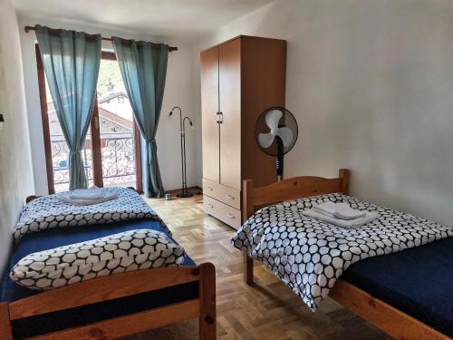 a bedroom with two twin beds and a window at Sobe Pri Olivi in Kobarid