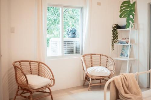 two chairs sitting in a room with a window at Private Beach Villa in Zambales in Sampong