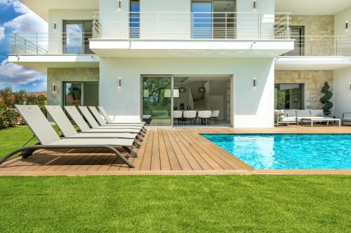 une villa avec piscine et chaises longues dans l'établissement Villa Jylloue Modern 6 chambres , 2 minutes from royal golf club, à Mougins