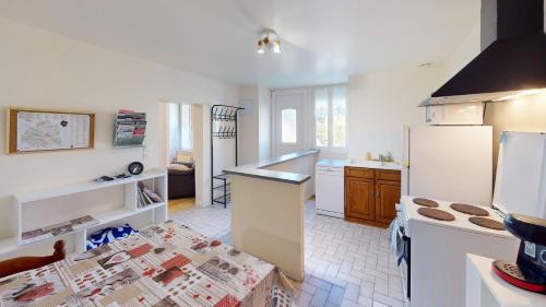 a kitchen with a refrigerator and a counter top at Maison Juloucam in Éguzon-Chantôme