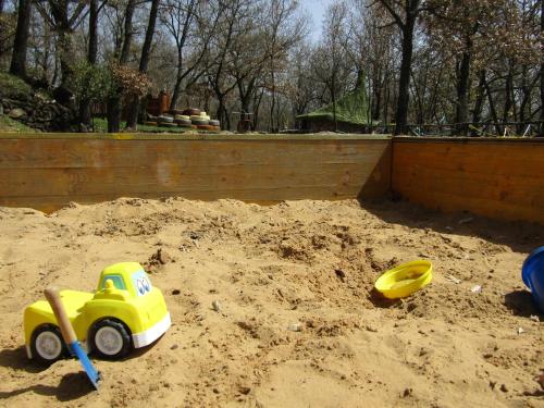 a toy truck in the sand in a sandbox at Boscoscuro in Ragalna