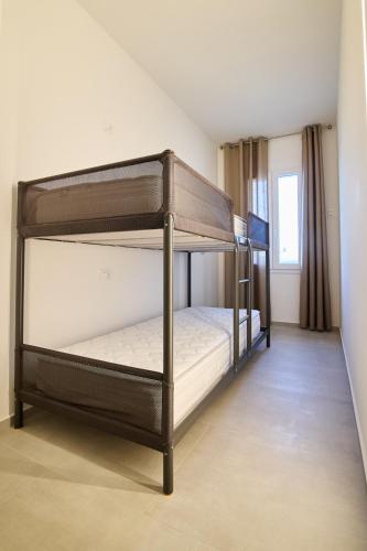a bedroom with two bunk beds in a room at Casa Moma in Marotta