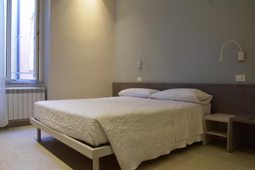 a bedroom with a large bed with white sheets and pillows at Marinucci Rooms in Termoli