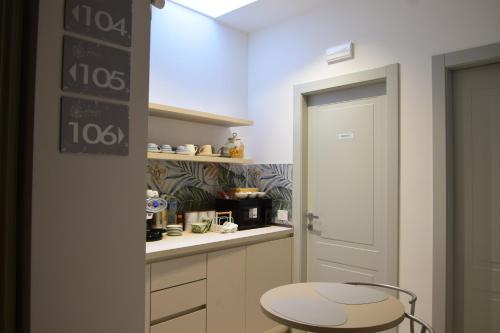 a kitchen with a stool next to a door at Marinucci Rooms in Termoli