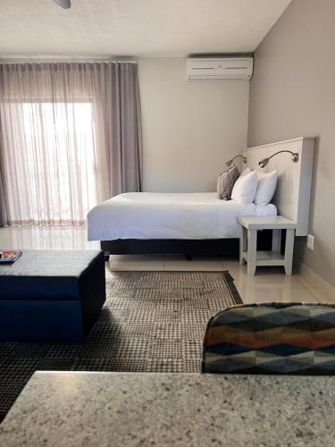 Ένα ή περισσότερα κρεβάτια σε δωμάτιο στο Hillside Executive Accommodation