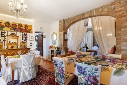 a dining room with a table and a brick wall at Locanda Casa Bardacchino in Mango