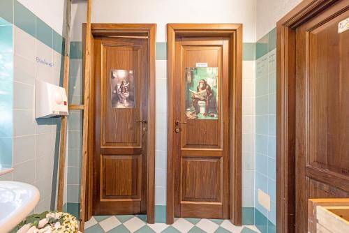 two wooden doors in a bathroom with a sink at Locanda Casa Bardacchino in Mango