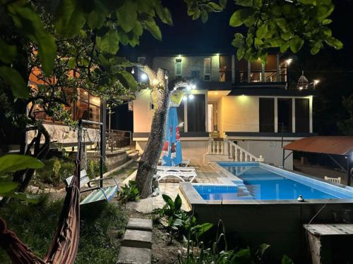 a villa with a swimming pool at night at hill-fort kutaisi in Kutaisi