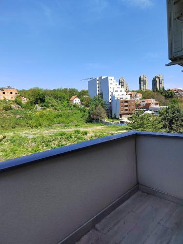 a balcony with a view of a city at Lux Apartman Banjica in Bukorovac