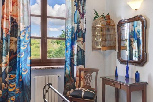 a room with a window and a table and a chair at Locanda Casa Bardacchino in Mango