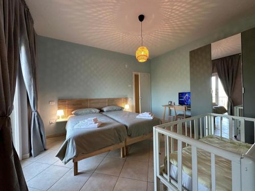a bedroom with a bed in a room with a staircase at Cinelli Apartment Stio Cilento in Magliano Nuovo