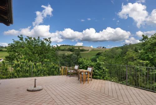 a patio with a table and chairs and a fence at Locanda Casa Bardacchino in Mango