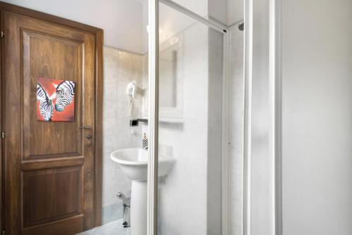 a bathroom with a toilet and a glass shower door at Locanda Casa Bardacchino in Mango