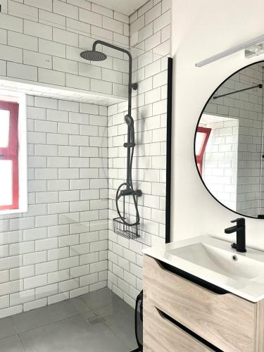 a white bathroom with a shower and a sink at Quinta do Atlântico in Biscoitos