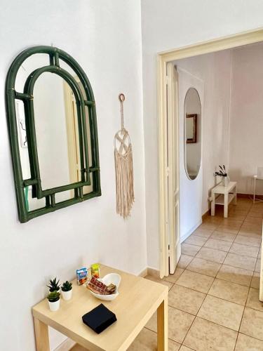 a room with a table and a mirror on the wall at Casa Myda in Bari