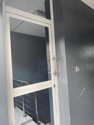 a glass door with a window in a room at Umbrella Properties hotels and apartments - Moniya in Ibadan