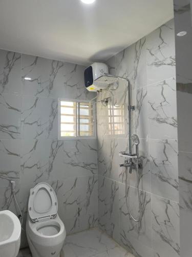 a bathroom with a toilet and a sink at Umbrella Properties hotels and apartments - Moniya in Ibadan