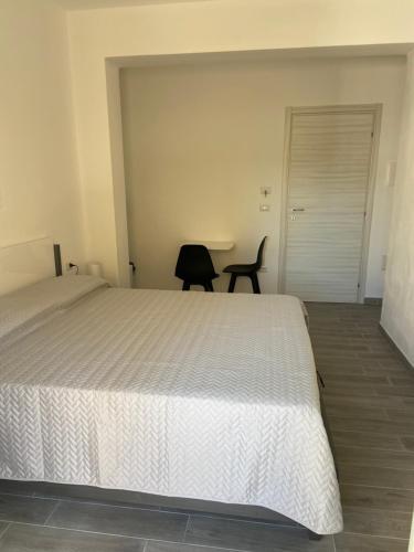 a bedroom with a bed and a table and a chair at La Giara in Alghero