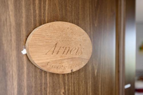 a sign on a wooden door with the word autism on it at Locanda Casa Bardacchino in Mango