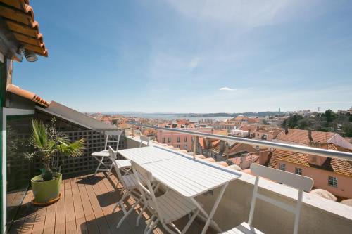 a balcony with a table and chairs and a view at LV Premier Apartments P.Real- PI in Lisbon