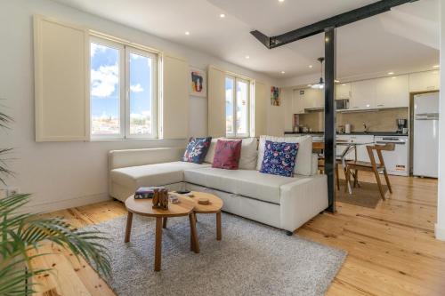 a living room with a white couch and a table at LV Premier Apartments P.Real- PI in Lisbon