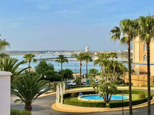 a view of a body of water with palm trees at Atlántico, Playa Punta del Moral - By AC REAL in Punta del moral