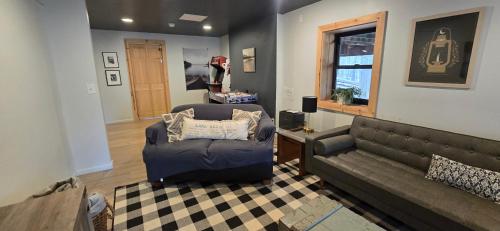 a living room with a couch and a chair at Golden A Frame- 3 bedroom with hot tub and community amenities in Swanton