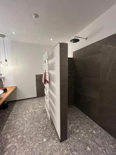 a bathroom with a sink and a toilet in a room at Ferienwohung Dennabruck mit Whirlpool in Dietramszell