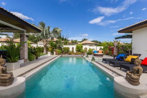 a swimming pool in a villa with a house at Orchid Paradise Homes Villa in Hua Hin