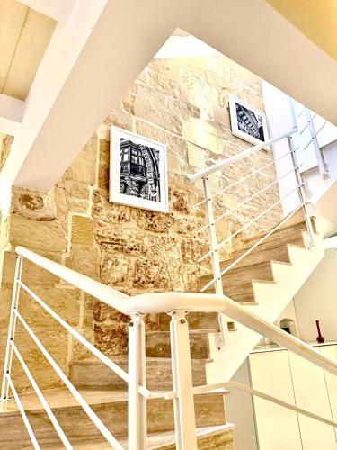 a staircase in a building with two pictures on the wall at Charming 3-Bedroom House of Character - Perfect Family Retreat - Naxxar in Il-Gwejdi