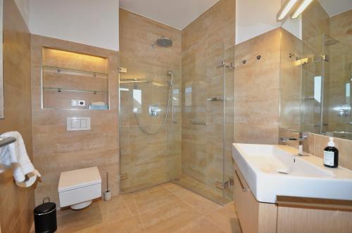 a bathroom with a shower and a sink and a shower at Appartement Penthouse in St. Peter-Ording