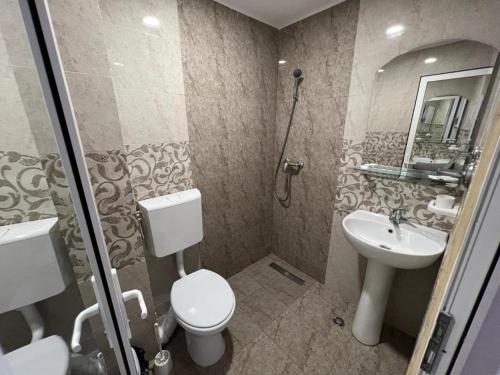 a bathroom with a toilet and a sink at Claudia in Eforie Sud