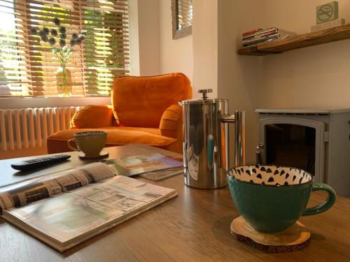 a living room with a coffee table and a chair at Minster Cottage - Cathedral Quarter with Free Parking in Lincoln