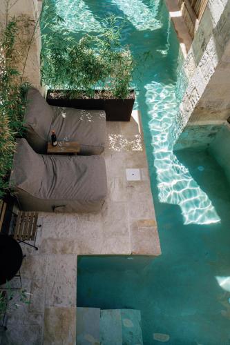 an overhead view of a pool of water with plants at Amalen Suites Adults Only in Rethymno Town
