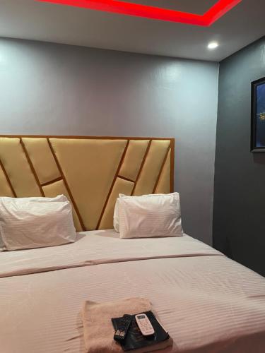 a hotel room with a bed with a tray on it at Umbrella Properties hotels and apartments - Moniya in Ibadan