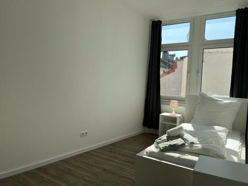a bedroom with a bed and a large window at Convenient Apartment for 3 in Offenbach