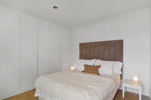a bedroom with a bed with a brown pillow on it at Suitme-Agaete in Agaete