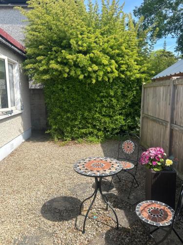 a small patio with a table and two chairs at Small, perfectly formed studio in Dublin