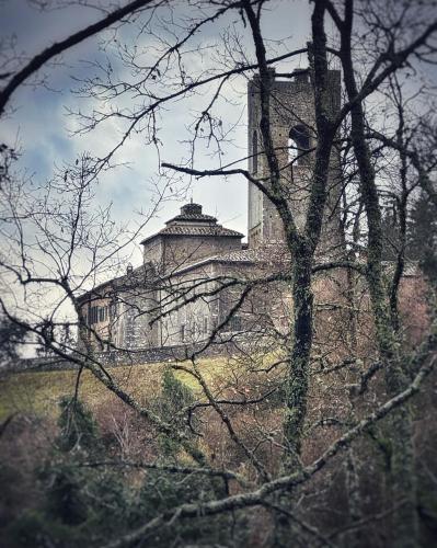 an old building sitting on top of a hill at Badia a Coltibuono Wine Resort in Gaiole in Chianti
