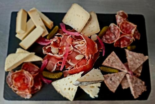 a plate of food with cheese and meats and crackers at Auberge Arthéa in Laviolle