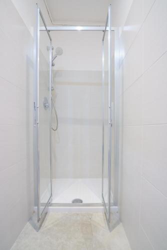 a shower with a glass door in a bathroom at Da Rocky in Riomaggiore