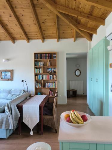 a living room with a table and a bowl of fruit at Villa Elsa in Petra
