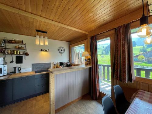 - une cuisine avec un comptoir et une fenêtre dans une pièce dans l'établissement Appartement cosy 6 pers, centre Cernix, pied des pistes, proche commerces et ESF - FR-1-733-52, à Crest-Voland