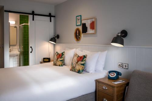 a bedroom with a large white bed with pillows at Middletons in York