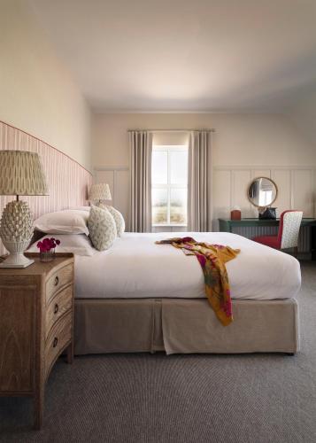 a large bedroom with a large bed and a window at Teach de Broc in Ballybunion