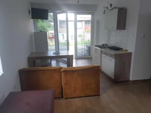 a room with a kitchen with a table and a counter at Apartman Novi Sad - Apartment Novi Sad in Sremska Kamenica