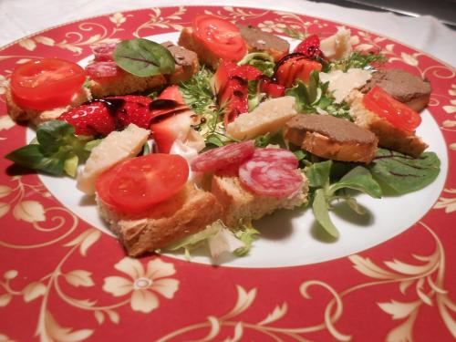 a plate of food with a salad on it at Lo Spedalicchio in Bastia Umbra