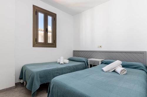 Postel nebo postele na pokoji v ubytování Alcudia Apartments