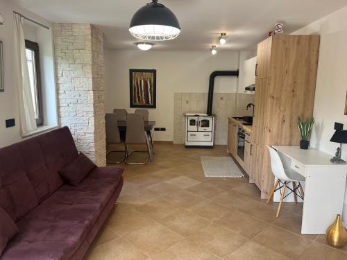 a living room with a couch and a kitchen at Villa Markisa in Rukavac
