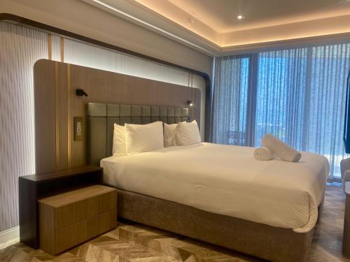 a bedroom with a large bed and a large window at Coastlands Skye Hotel, Ridgeside, Umhlanga in Durban